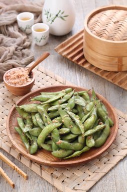 Edamame is Japanese dish and prepared of immature soybeans in the pod. The pods are boiled or steamed and may be served with salt or other condiments. Nowadays it became to be so popular in the world 
