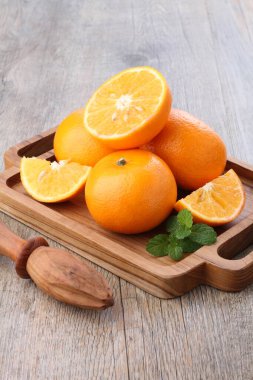 fresh juicy oranges and sliced on a wooden table
