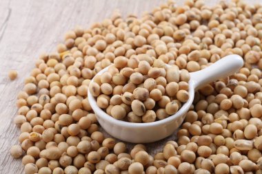 raw chickpeas in a bowl on a wooden spoon
