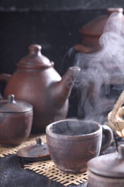 Tea is an aromatic beverage prepared by pouring hot or boiling water over cured or fresh leaves of Camellia sinensis, an evergreen shrub native to East Asia which probably originated in the borderlands of southwestern China and northern Myanmar. 