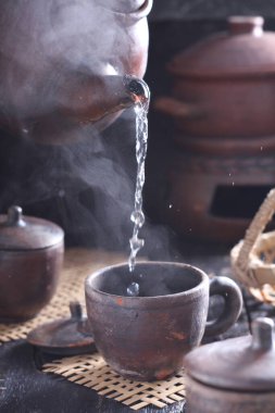 Tea is an aromatic beverage prepared by pouring hot or boiling water over cured or fresh leaves of Camellia sinensis, an evergreen shrub native to East Asia which probably originated in the borderlands of southwestern China and northern Myanmar. 