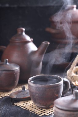 Tea is an aromatic beverage prepared by pouring hot or boiling water over cured or fresh leaves of Camellia sinensis, an evergreen shrub native to East Asia which probably originated in the borderlands of southwestern China and northern Myanmar. 