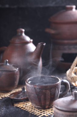 Tea is an aromatic beverage prepared by pouring hot or boiling water over cured or fresh leaves of Camellia sinensis, an evergreen shrub native to East Asia which probably originated in the borderlands of southwestern China and northern Myanmar. 