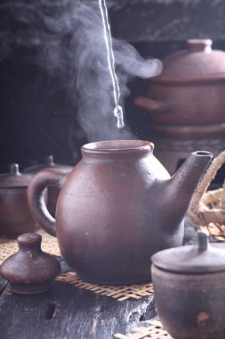 Tea is an aromatic beverage prepared by pouring hot or boiling water over cured or fresh leaves of Camellia sinensis, an evergreen shrub native to East Asia which probably originated in the borderlands of southwestern China and northern Myanmar. 