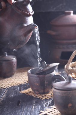 Tea is an aromatic beverage prepared by pouring hot or boiling water over cured or fresh leaves of Camellia sinensis, an evergreen shrub native to East Asia which probably originated in the borderlands of southwestern China and northern Myanmar. 