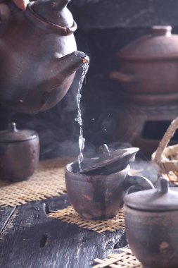 Tea is an aromatic beverage prepared by pouring hot or boiling water over cured or fresh leaves of Camellia sinensis, an evergreen shrub native to East Asia which probably originated in the borderlands of southwestern China and northern Myanmar. 