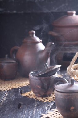 Tea is an aromatic beverage prepared by pouring hot or boiling water over cured or fresh leaves of Camellia sinensis, an evergreen shrub native to East Asia which probably originated in the borderlands of southwestern China and northern Myanmar. 