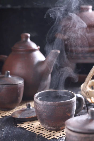 stock image Tea is an aromatic beverage prepared by pouring hot or boiling water over cured or fresh leaves of Camellia sinensis, an evergreen shrub native to East Asia which probably originated in the borderlands of southwestern China and northern Myanmar. 