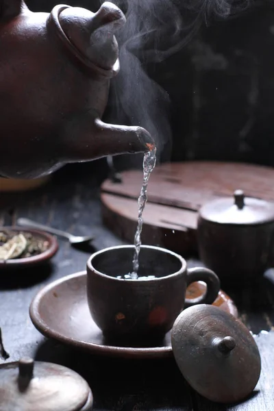 Tea is an aromatic beverage prepared by pouring hot or boiling water over cured or fresh leaves of Camellia sinensis, an evergreen shrub native to East Asia which probably originated in the borderlands of southwestern China and northern Myanmar.
