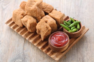 Sos ve ahşap arka planda sebzeli domuz pirzolası.