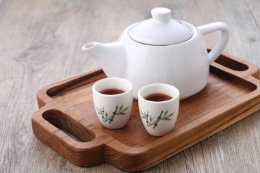 Tea is an aromatic beverage prepared by pouring hot or boiling water over cured or fresh leaves of Camellia sinensis, an evergreen shrub native to East Asia which probably originated in the borderlands of southwestern China and northern Myanmar.