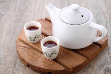 Tea is an aromatic beverage prepared by pouring hot or boiling water over cured or fresh leaves of Camellia sinensis, an evergreen shrub native to East Asia which probably originated in the borderlands of southwestern China and northern Myanmar.