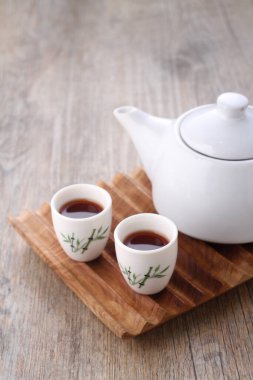 Tea is an aromatic beverage prepared by pouring hot or boiling water over cured or fresh leaves of Camellia sinensis, an evergreen shrub native to East Asia which probably originated in the borderlands of southwestern China and northern Myanmar.