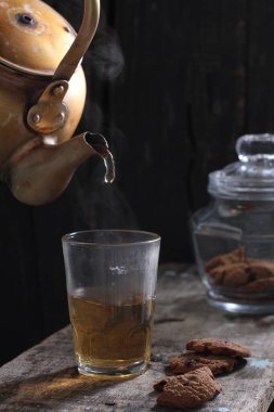 Tea is an aromatic beverage prepared by pouring hot or boiling water over cured or fresh leaves of Camellia sinensis, an evergreen shrub native to East Asia which probably originated in the borderlands of southwestern China and northern Myanmar. 