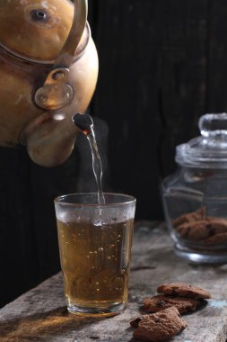 Tea is an aromatic beverage prepared by pouring hot or boiling water over cured or fresh leaves of Camellia sinensis, an evergreen shrub native to East Asia which probably originated in the borderlands of southwestern China and northern Myanmar. 