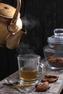 Tea is an aromatic beverage prepared by pouring hot or boiling water over cured or fresh leaves of Camellia sinensis, an evergreen shrub native to East Asia which probably originated in the borderlands of southwestern China and northern Myanmar. 