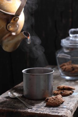 Tea is an aromatic beverage prepared by pouring hot or boiling water over cured or fresh leaves of Camellia sinensis, an evergreen shrub native to East Asia which probably originated in the borderlands of southwestern China and northern Myanmar. 