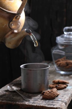 Tea is an aromatic beverage prepared by pouring hot or boiling water over cured or fresh leaves of Camellia sinensis, an evergreen shrub native to East Asia which probably originated in the borderlands of southwestern China and northern Myanmar. 