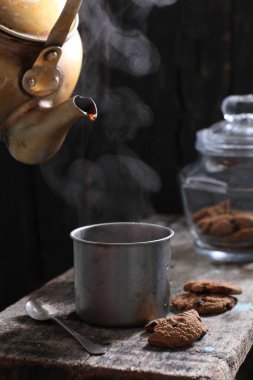 Tea is an aromatic beverage prepared by pouring hot or boiling water over cured or fresh leaves of Camellia sinensis, an evergreen shrub native to East Asia which probably originated in the borderlands of southwestern China and northern Myanmar. 