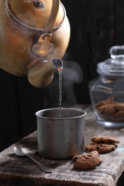 Tea is an aromatic beverage prepared by pouring hot or boiling water over cured or fresh leaves of Camellia sinensis, an evergreen shrub native to East Asia which probably originated in the borderlands of southwestern China and northern Myanmar. 