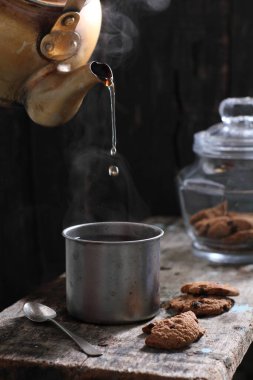 Tea is an aromatic beverage prepared by pouring hot or boiling water over cured or fresh leaves of Camellia sinensis, an evergreen shrub native to East Asia which probably originated in the borderlands of southwestern China and northern Myanmar. 