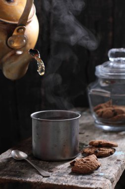 Tea is an aromatic beverage prepared by pouring hot or boiling water over cured or fresh leaves of Camellia sinensis, an evergreen shrub native to East Asia which probably originated in the borderlands of southwestern China and northern Myanmar. 