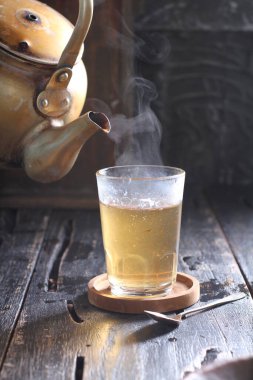 Tea is an aromatic beverage prepared by pouring hot or boiling water over cured or fresh leaves of Camellia sinensis, an evergreen shrub native to East Asia which probably originated in the borderlands of southwestern China and northern Myanmar. 