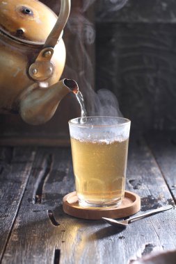 Tea is an aromatic beverage prepared by pouring hot or boiling water over cured or fresh leaves of Camellia sinensis, an evergreen shrub native to East Asia which probably originated in the borderlands of southwestern China and northern Myanmar. 