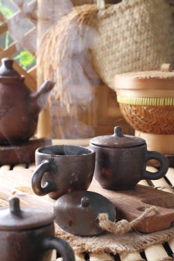 Tea is an aromatic beverage prepared by pouring hot or boiling water over cured or fresh leaves of Camellia sinensis, an evergreen shrub native to East Asia which probably originated in the borderlands of southwestern China and northern Myanmar. 