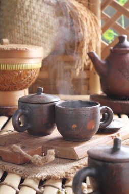 Tea is an aromatic beverage prepared by pouring hot or boiling water over cured or fresh leaves of Camellia sinensis, an evergreen shrub native to East Asia which probably originated in the borderlands of southwestern China and northern Myanmar. 