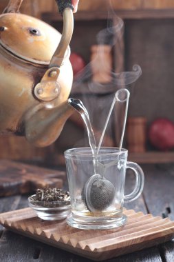 Tea is an aromatic beverage prepared by pouring hot or boiling water over cured or fresh leaves of Camellia sinensis, an evergreen shrub native to East Asia which probably originated in the borderlands of southwestern China and northern Myanmar.