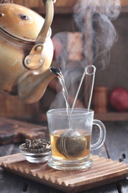 Tea is an aromatic beverage prepared by pouring hot or boiling water over cured or fresh leaves of Camellia sinensis, an evergreen shrub native to East Asia which probably originated in the borderlands of southwestern China and northern Myanmar.