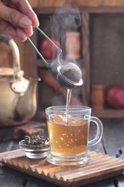 Tea is an aromatic beverage prepared by pouring hot or boiling water over cured or fresh leaves of Camellia sinensis, an evergreen shrub native to East Asia which probably originated in the borderlands of southwestern China and northern Myanmar.