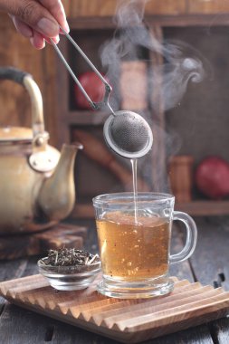 Tea is an aromatic beverage prepared by pouring hot or boiling water over cured or fresh leaves of Camellia sinensis, an evergreen shrub native to East Asia which probably originated in the borderlands of southwestern China and northern Myanmar.
