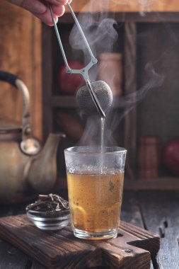 Tea is an aromatic beverage prepared by pouring hot or boiling water over cured or fresh leaves of Camellia sinensis, an evergreen shrub native to East Asia which probably originated in the borderlands of southwestern China and northern Myanmar.