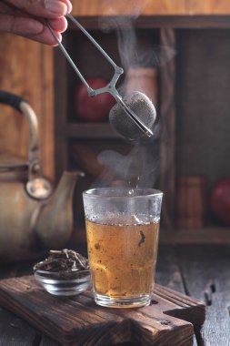 Tea is an aromatic beverage prepared by pouring hot or boiling water over cured or fresh leaves of Camellia sinensis, an evergreen shrub native to East Asia which probably originated in the borderlands of southwestern China and northern Myanmar.