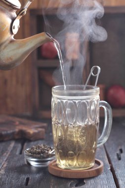 Tea is an aromatic beverage prepared by pouring hot or boiling water over cured or fresh leaves of Camellia sinensis, an evergreen shrub native to East Asia which probably originated in the borderlands of southwestern China and northern Myanmar.