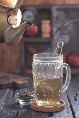 Tea is an aromatic beverage prepared by pouring hot or boiling water over cured or fresh leaves of Camellia sinensis, an evergreen shrub native to East Asia which probably originated in the borderlands of southwestern China and northern Myanmar.