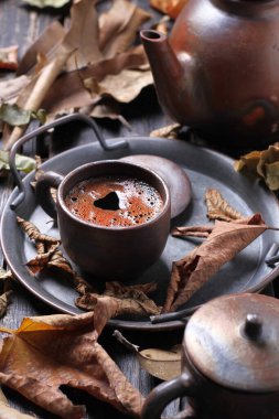 Tea is an aromatic beverage prepared by pouring hot or boiling water over cured or fresh leaves of Camellia sinensis, an evergreen shrub native to East Asia which probably originated in the borderlands of southwestern China and northern Myanmar.