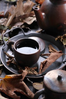 Tea is an aromatic beverage prepared by pouring hot or boiling water over cured or fresh leaves of Camellia sinensis, an evergreen shrub native to East Asia which probably originated in the borderlands of southwestern China and northern Myanmar.