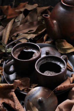 Tea is an aromatic beverage prepared by pouring hot or boiling water over cured or fresh leaves of Camellia sinensis, an evergreen shrub native to East Asia which probably originated in the borderlands of southwestern China and northern Myanmar.