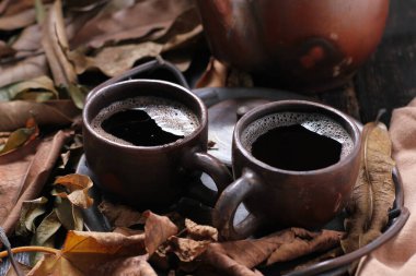 Tea is an aromatic beverage prepared by pouring hot or boiling water over cured or fresh leaves of Camellia sinensis, an evergreen shrub native to East Asia which probably originated in the borderlands of southwestern China and northern Myanmar.