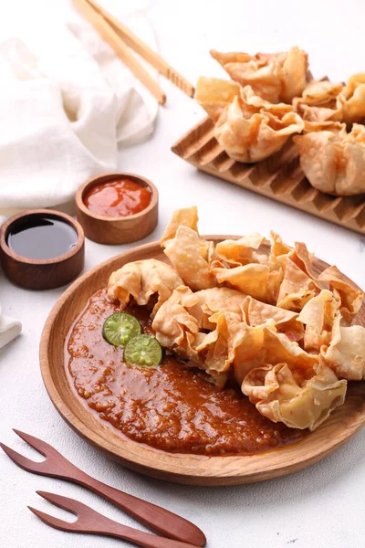 stock image Batagor  is a Sundanese dish from Indonesia, and popular in Southeast Asia, consisting of fried fish dumplings, usually served with peanut sauce. It is traditionally made from minced tenggiri, 