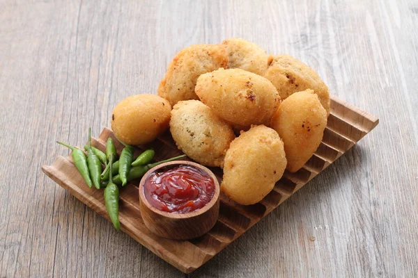 stock image Comro is a typical Sundanese fritter. Comro is made from grated cassava which is shaped round or oval and filled with chili sauce and chili sauce and fried. 