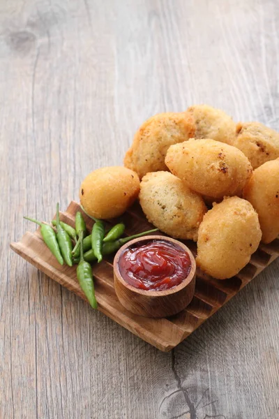 Stock image Comro is a typical Sundanese fritter. Comro is made from grated cassava which is shaped round or oval and filled with chili sauce and chili sauce and fried. 