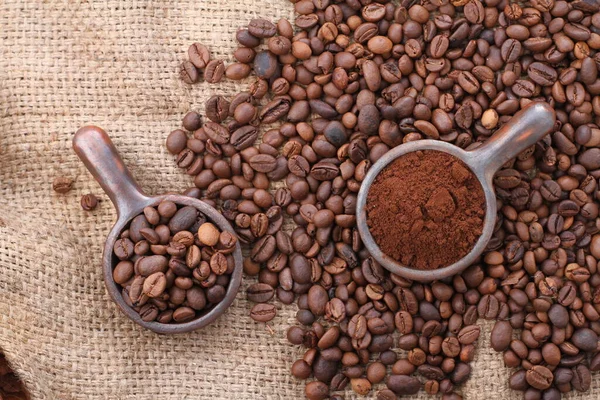 咖啡豆在一个褐色背景的木制勺子里 — 图库照片
