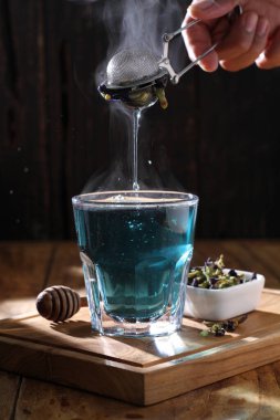 Tea is an aromatic beverage prepared by pouring hot or boiling water over cured or fresh leaves of Camellia sinensis, an evergreen shrub native to East Asia which probably originated in the borderlands of southwestern China and northern Myanmar