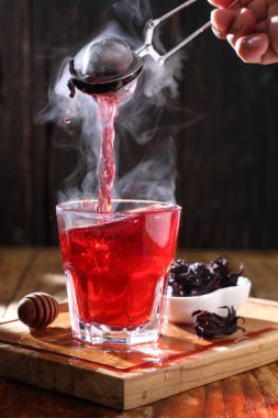 Tea is an aromatic beverage prepared by pouring hot or boiling water over cured or fresh leaves of Camellia sinensis, an evergreen shrub native to East Asia which probably originated in the borderlands of southwestern China and northern Myanmar.