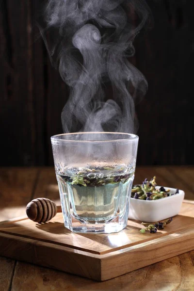 Tea is an aromatic beverage prepared by pouring hot or boiling water over cured or fresh leaves of Camellia sinensis, an evergreen shrub native to East Asia which probably originated in the borderlands of southwestern China and northern Myanmar