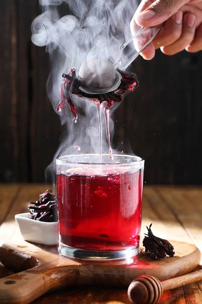 stock image Tea is an aromatic beverage prepared by pouring hot or boiling water over cured or fresh leaves of Camellia sinensis, an evergreen shrub native to East Asia which probably originated in the borderlands of southwestern China and northern Myanmar.